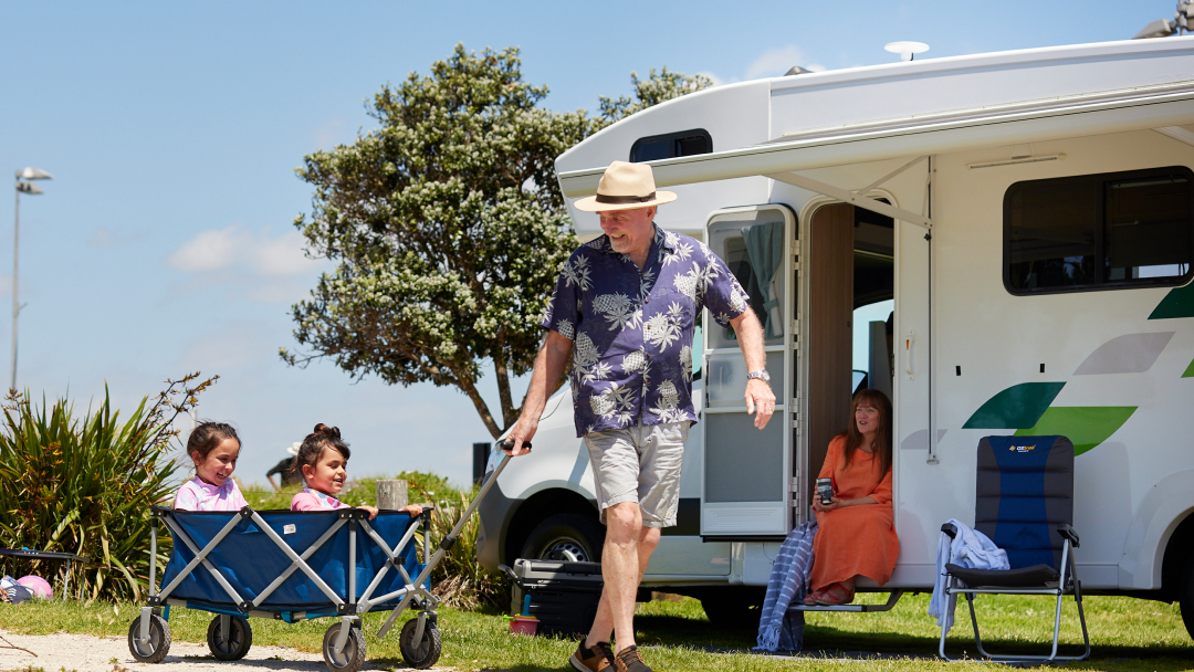 KEA motorhome family and kids outside in trolley