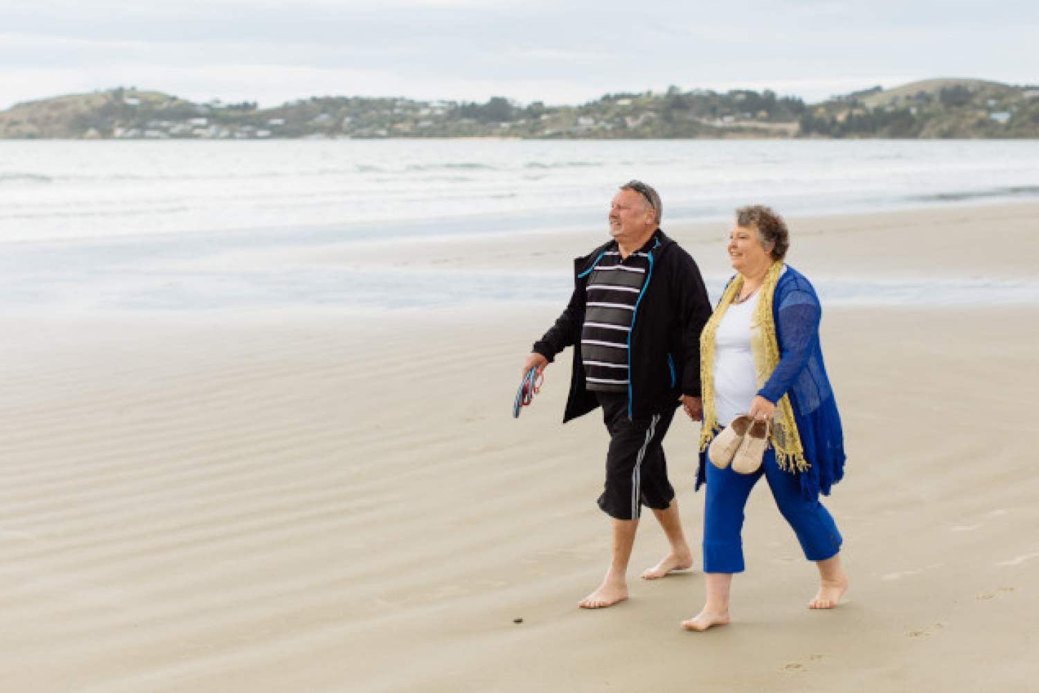 Happy couple walking on the beach