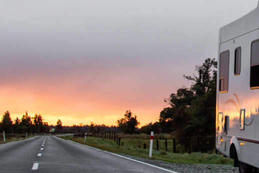 Motorhome parked on the side of the road during sunset