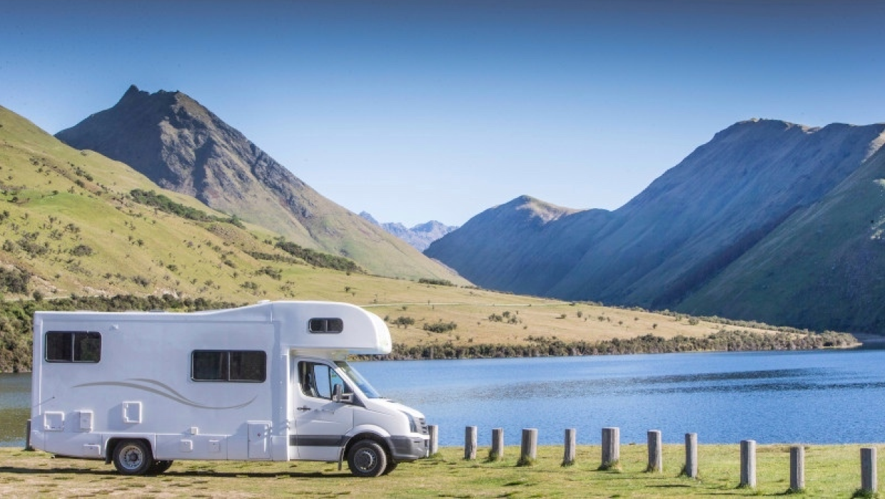  Motorhome parked up next to NZ scenery green mountains and lake