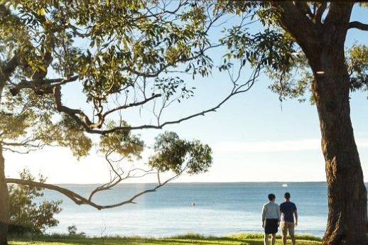 Holiday off grid with couple looking out to sea. 