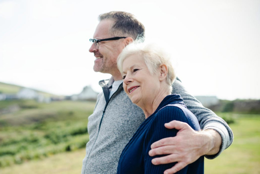 old couple looking out at view